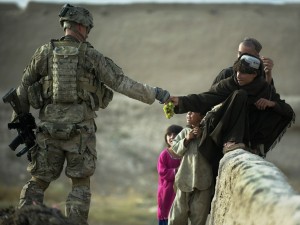 A U.S. soldier shares grapes with Afghan boys in the southern province of Kandahar on Wednesday.
